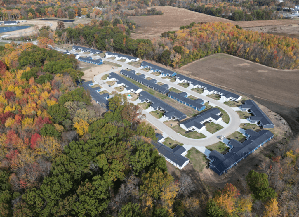 an aerial view of a parking lot surrounded by trees