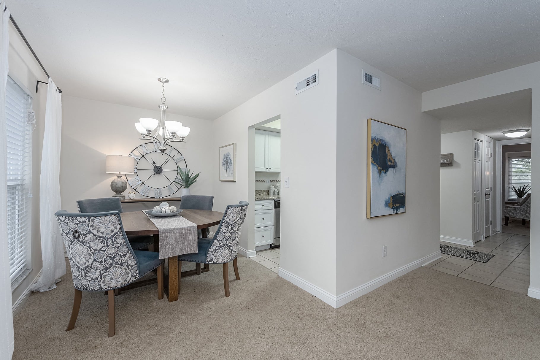 a dining room and living room with a table and chairs