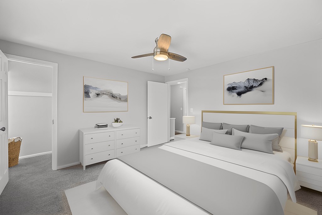 a white bedroom with a large bed and a ceiling fan a white bedroom with a large bed and a ceiling fan at Huntley Ridge, Kettering