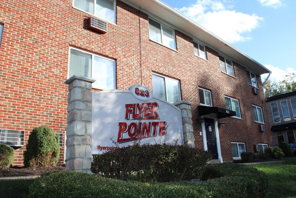 A brick building with a sign that says Flyer Pointe.