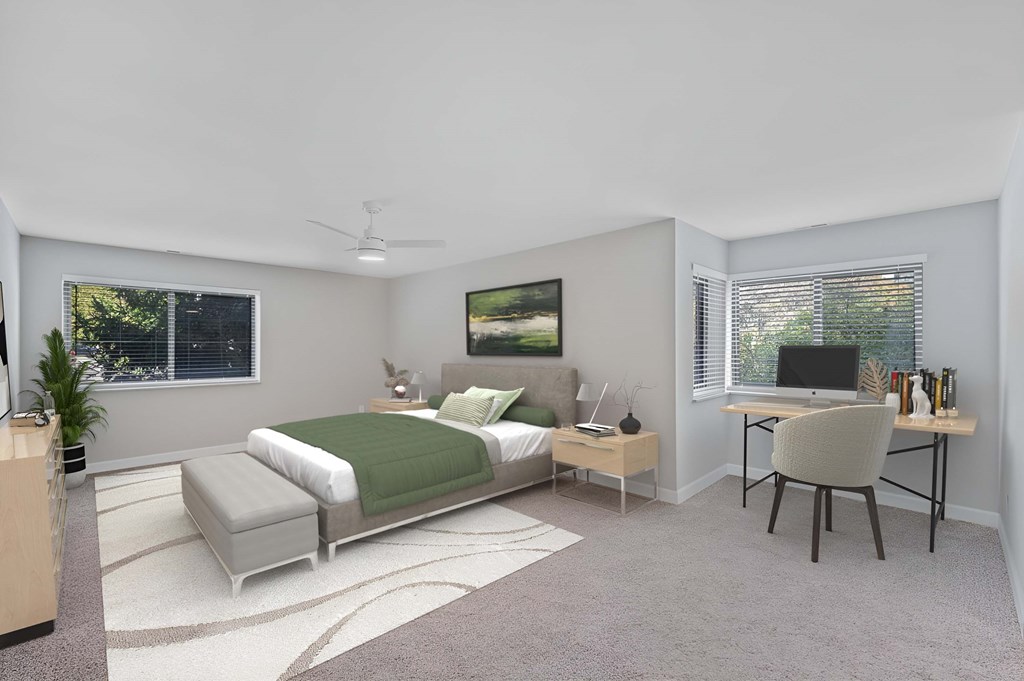 A bedroom with a bed, desk, and chair. at Indian Creek Apartments*, Cincinnati, Ohio