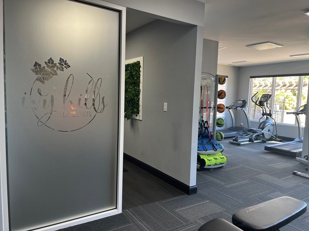 A gym with a glass wall and a sign that says