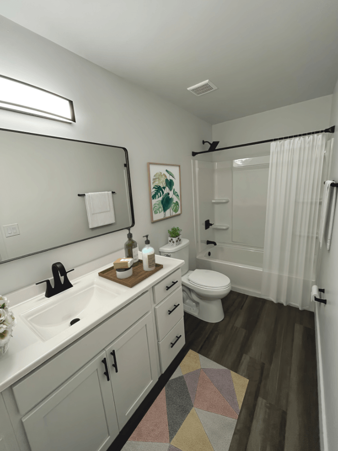 Remodeled bathroom with a white sink and toilet and a shower  at Ivy Hills Living Spaces, Cincinnati, OH
