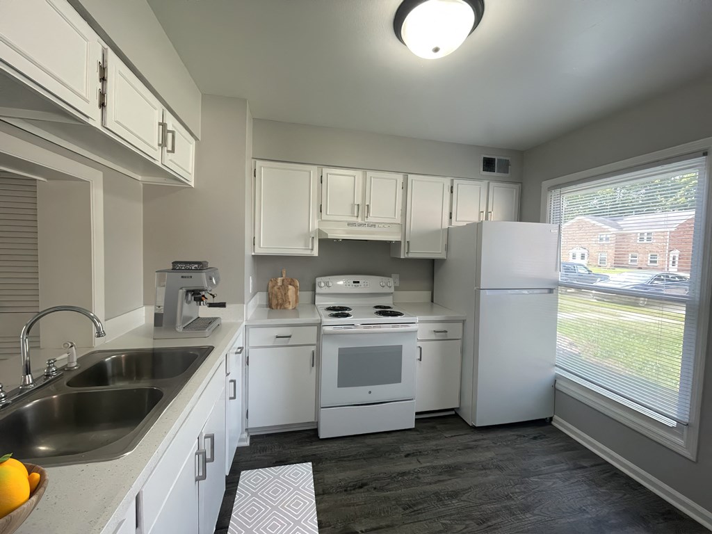 a kitchen with white appliances and white cabinets