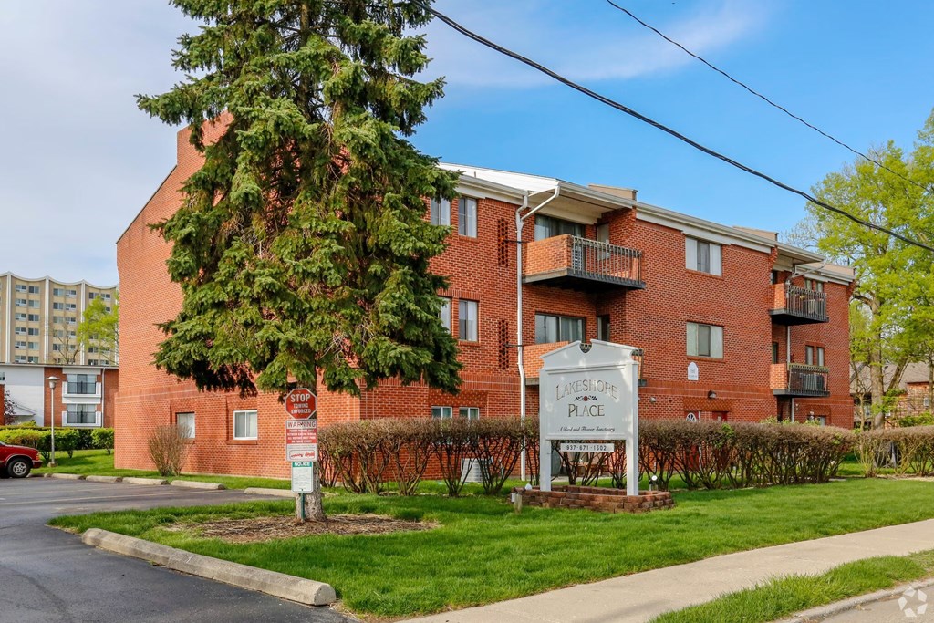 A red brick apartment building with a sign that says "Lakeside Place".