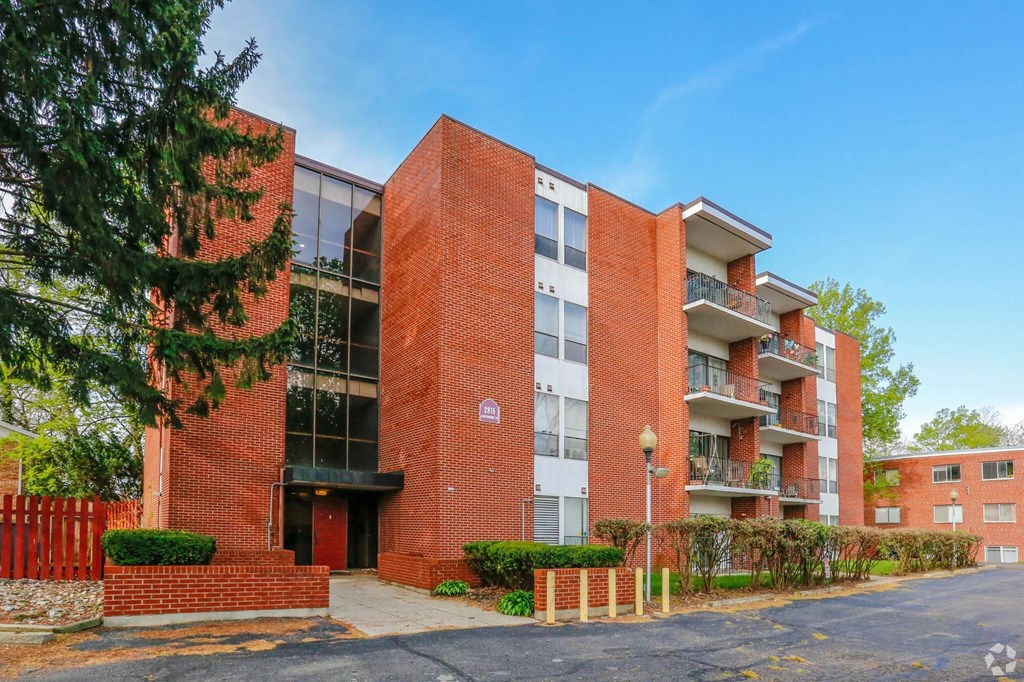 A red brick building with a black door and windows.