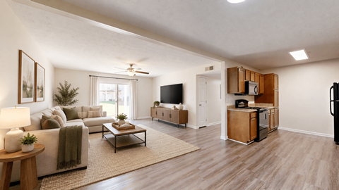 A living room with a couch, a coffee table, a television, and a refrigerator.