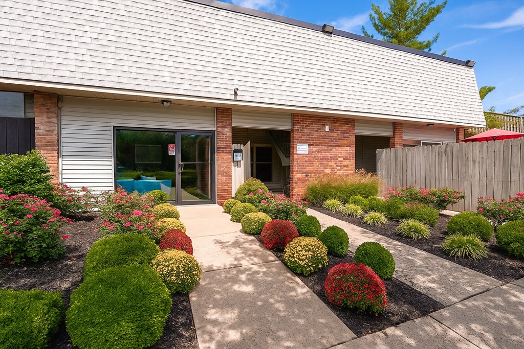 A house with a grey roof and a garden in front.