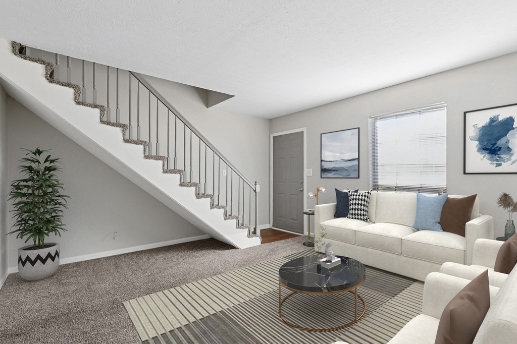 A living room with a staircase and a couch.