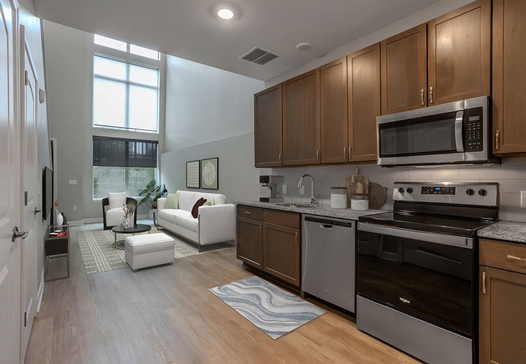 a kitchen and living room with wood floors and stainless steel appliances at Adelphi Quarter, Columbus, 43203