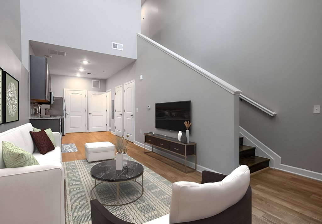 a living room with a couch and a table and a television at Adelphi Quarter, Columbus, Ohio