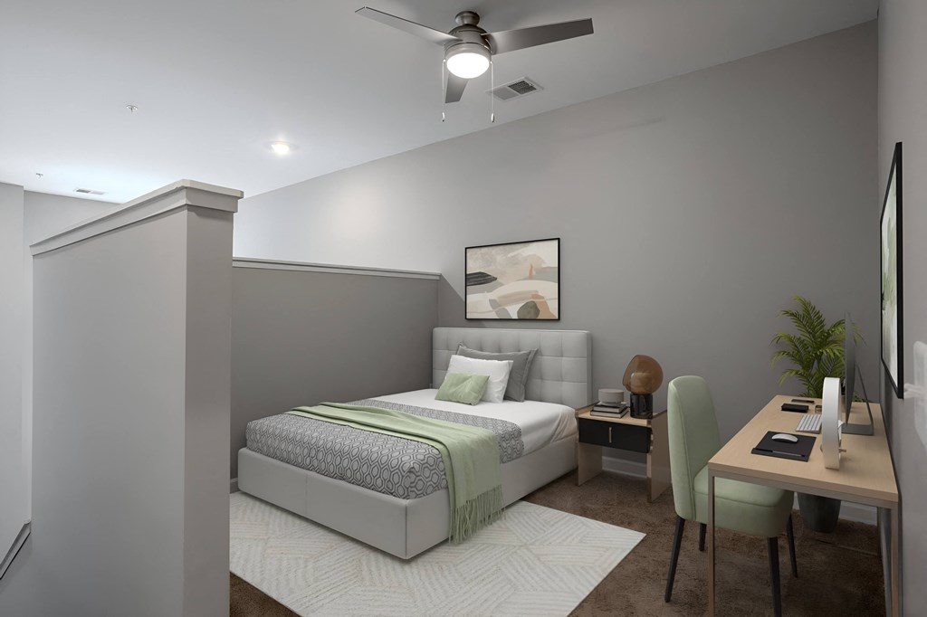 a bedroom with a bed and a desk and a ceiling fan at Adelphi Quarter, Columbus