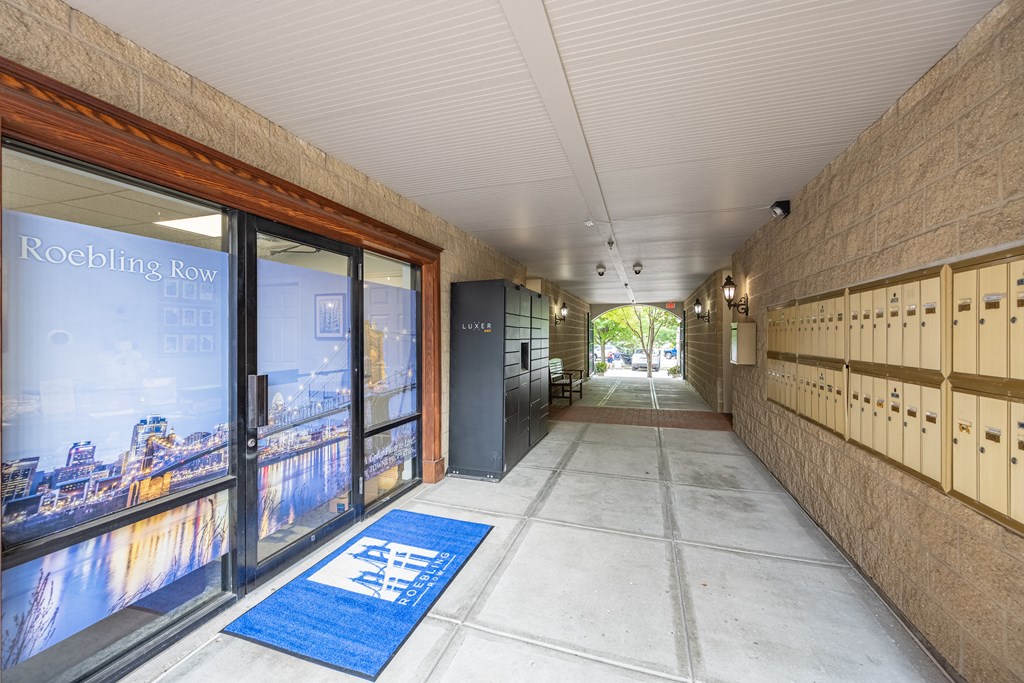 a hallway with doors and lockers in a building