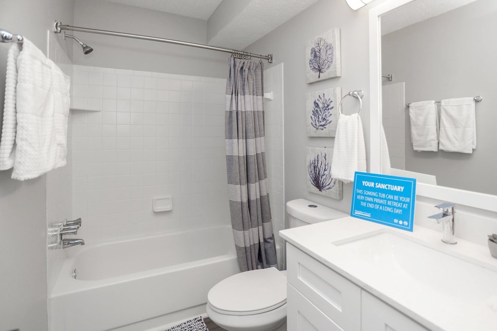 A bathroom with a towel hanging on the towel rack.