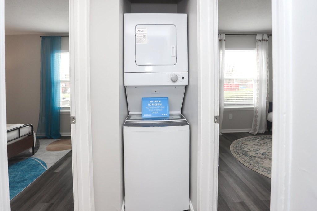 A small white box with a blue label is on top of a white refrigerator.