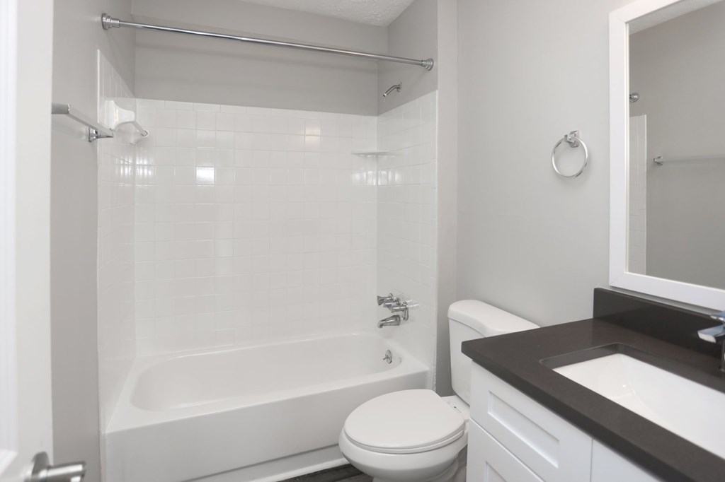A white toilet sits next to a sink in a bathroom.