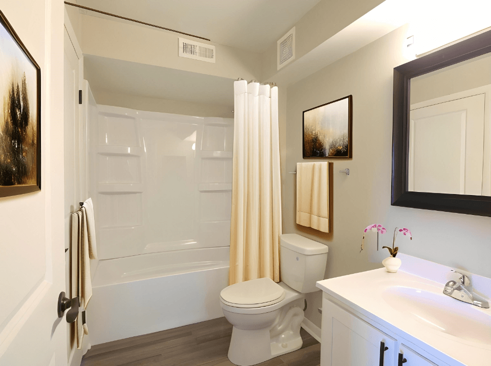 a bathroom with a toilet and a shower and a sink