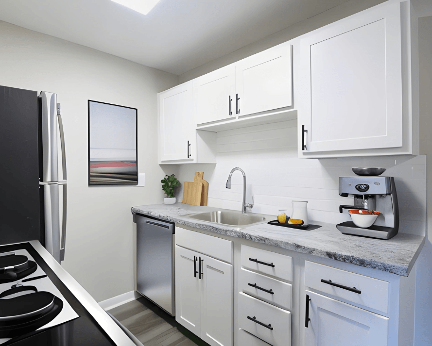a kitchen with white cabinets and a stainless steel refrigerator