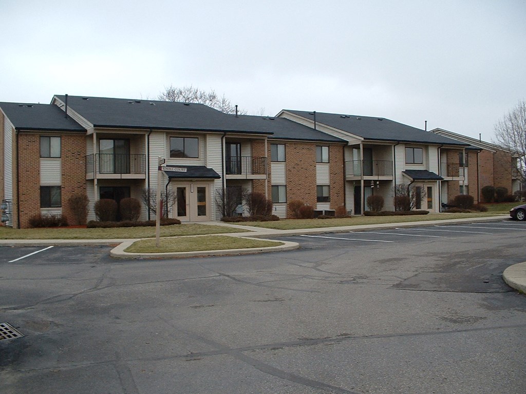 an empty street in front of an apartment building