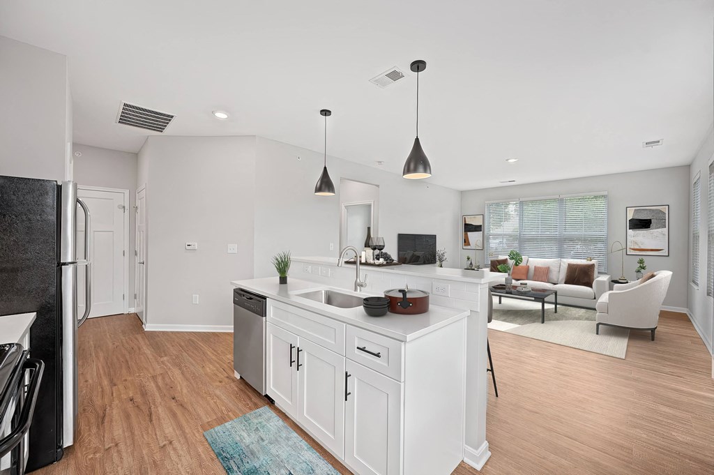 a white kitchen with an island and a living room at Monmouth Row Apartments, Newport, 41071