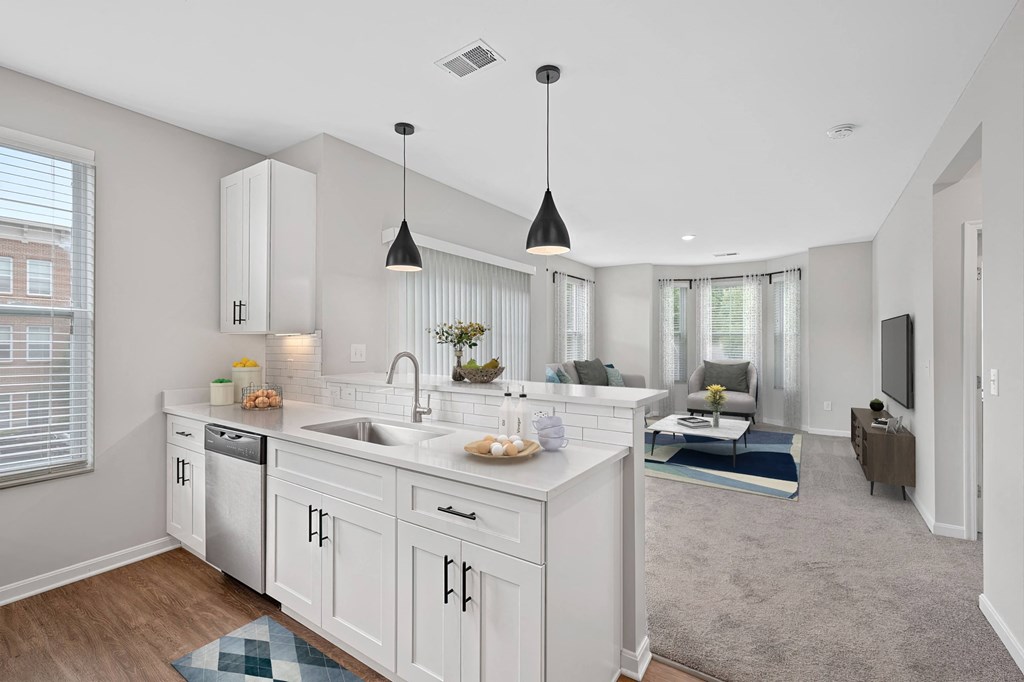 an open kitchen and living room with white cabinets and a white counter top at Monmouth Row Apartments, Kentucky