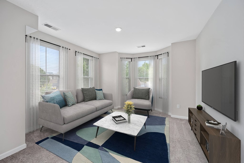 a living room with a couch and a coffee table and a tv at Monmouth Row Apartments, Newport