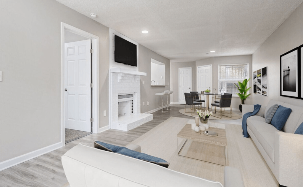 a living room and dining room with a fireplace and a tv at The Berryessa Apartments, Columbus, OH, 98104