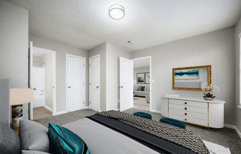 a bedroom with a bed and a dresser at The Berryessa Apartments, Ohio