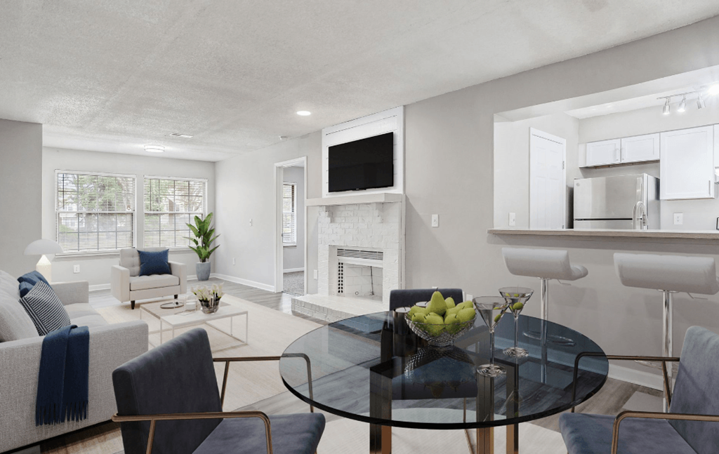 a living room with a glass table and a fireplace at The Berryessa Apartments, Columbus, 98104