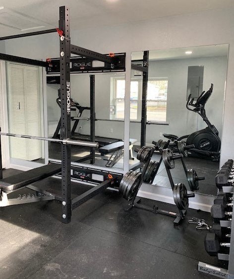 a gym with weights and a bike in it