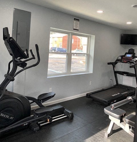 a gym with exercise equipment and a window
