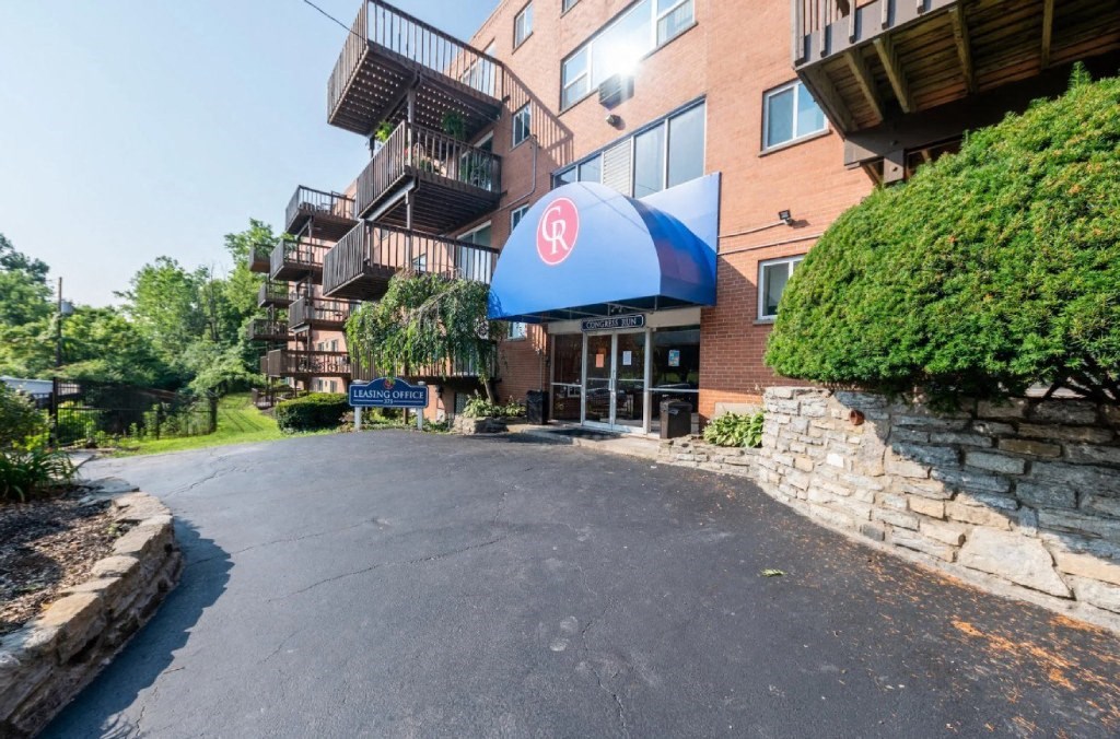 a large brick building with a blue awning in front of it