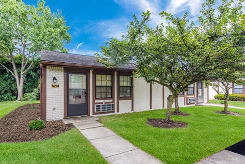 a small building with a sidewalk and trees in front of it at Parkside at Maple Canyon Apartments, Columbus, OH 43229