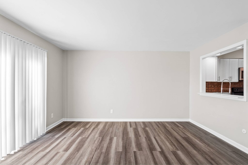 A room with wooden flooring and a large mirror on the wall at Fountain Parc Apartments, Indianapolis, IN 46220