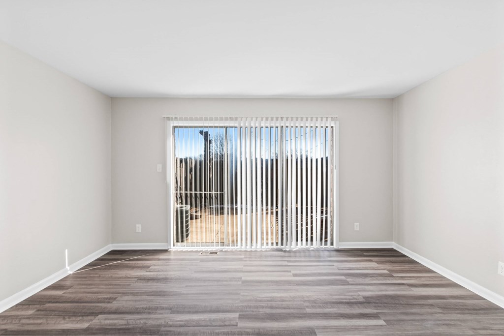 A room with a large window and a wooden floor at Fountain Parc Apartments, Indianapolis, 46220