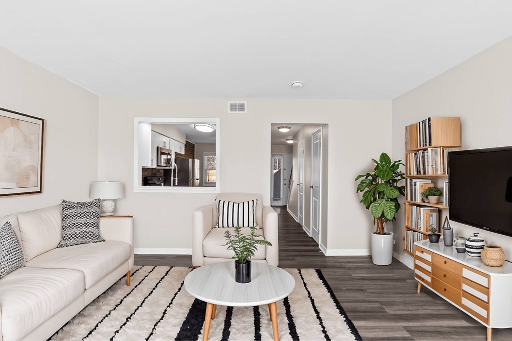 A living room with a white couch and a coffee table at Fountain Parc Apartments, Indianapolis, Indiana