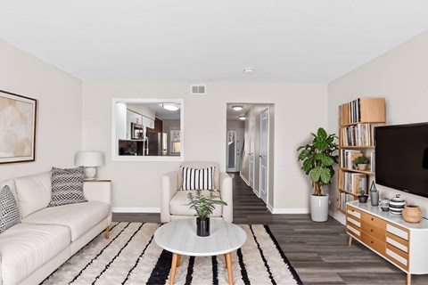 A living room with a white couch and a coffee table at Fountain Parc Apartments, Indianapolis, Indiana