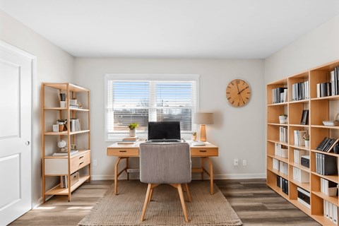 A room with a desk, chair, and bookshelves at Fountain Parc Apartments, Indianapolis, IN 46220