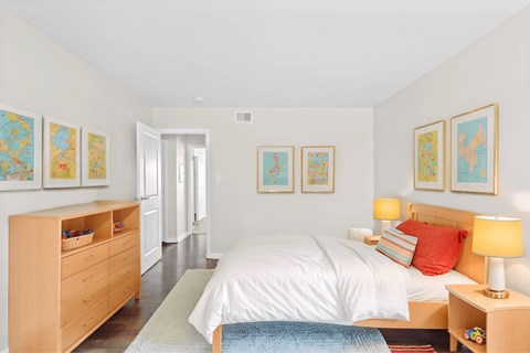 A bedroom with a bed, nightstand, and a dresser with drawers at Fountain Parc Apartments, Indianapolis, IN 46220