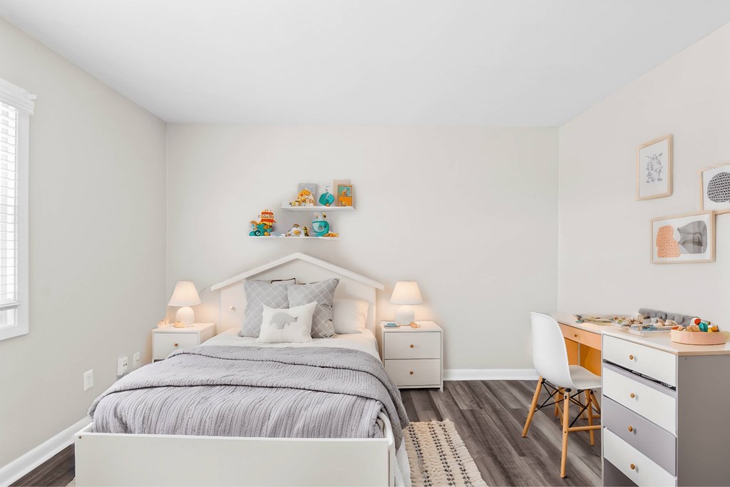 A bedroom with a bed, desk, and chair at Fountain Parc Apartments, Indianapolis, IN 46220