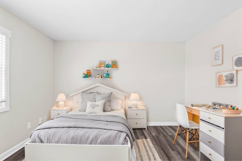 A bedroom with a bed, desk, and chair at Fountain Parc Apartments, Indianapolis, IN 46220
