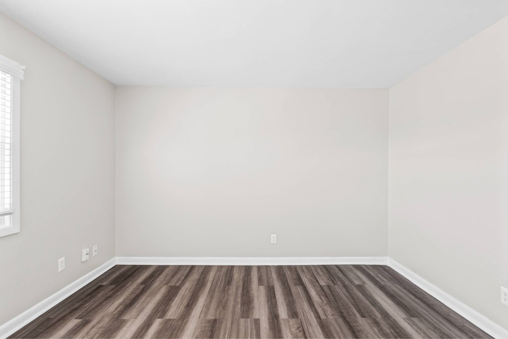 A room with wooden flooring and white walls at Fountain Parc Apartments, Indianapolis, IN