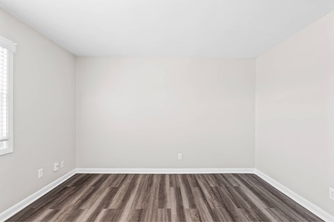 A room with wooden flooring and white walls at Fountain Parc Apartments, Indianapolis, IN