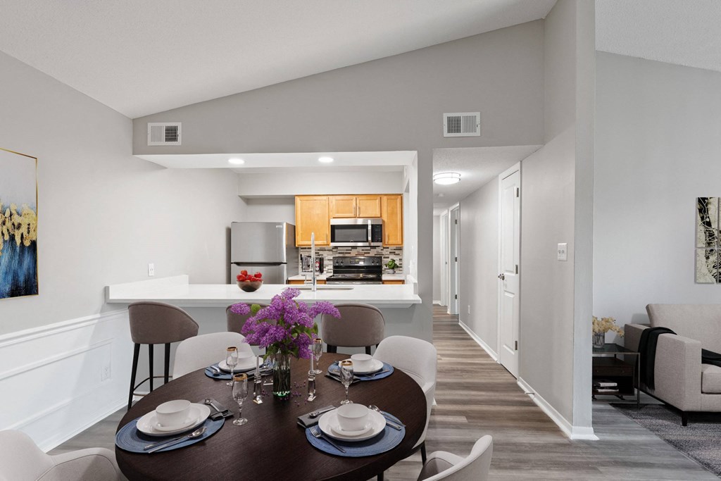 A modern dining room with a table set for two.