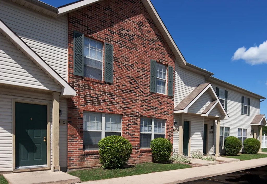 A row of houses with a blue sky in the background.