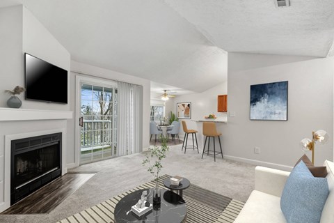 A living room with a fireplace and a television on the wall.