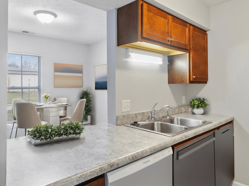 our apartments offer a kitchen and dining area with a table and chairs