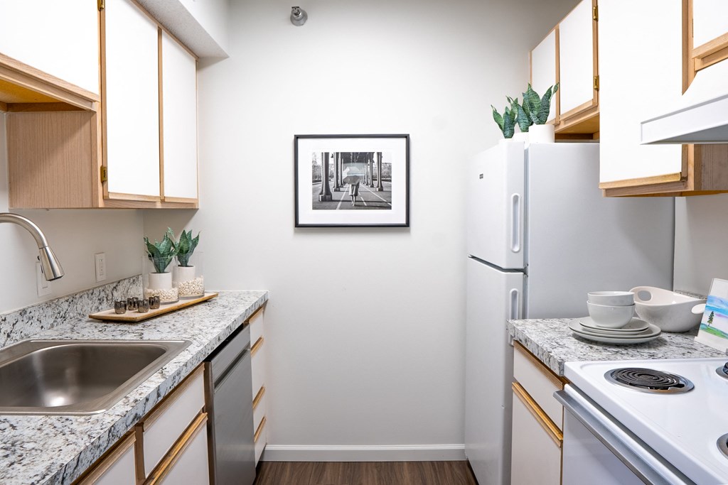a kitchen with granite countertops and white appliances
