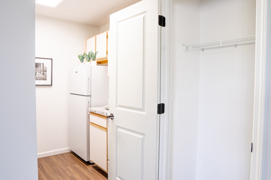 a kitchen with a white refrigerator freezer next to a white door