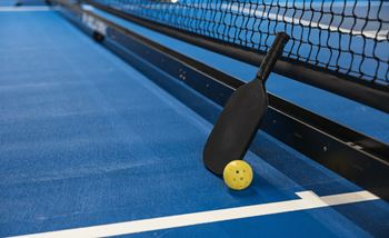 a paddle and ball on a ping pong table